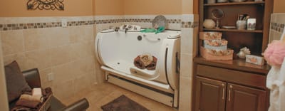 Accessible bathing area in a facility bathroom