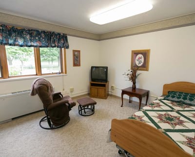 Cozy resident room with a bed and seating area