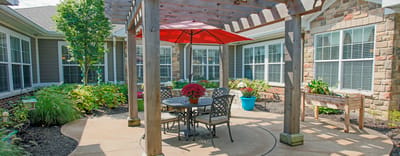 Outdoor seating area with a pergola and flowers