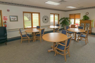 Brightly lit common area with tables and chairs