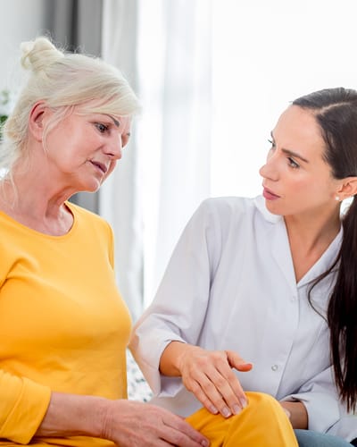 Caregiver engaging with a resident in a bright interior