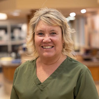 Staff member smiling in a facility interior