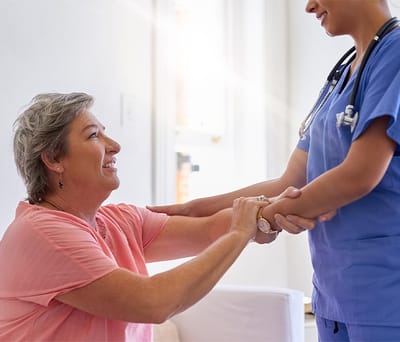A caregiver assisting a resident in a facility setting