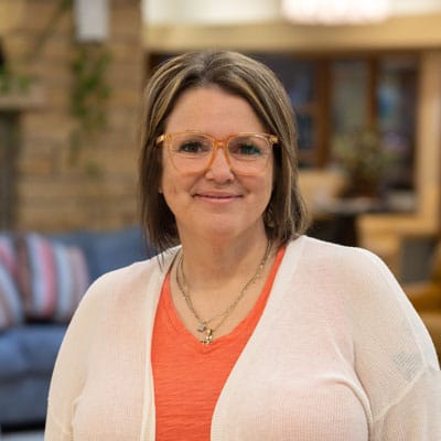 Staff member smiling in a comfortable common area