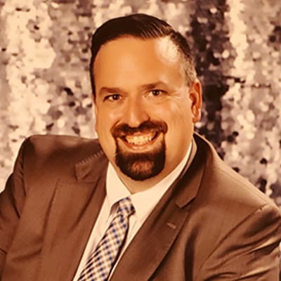 Portrait of a man in a suit with a blurred background