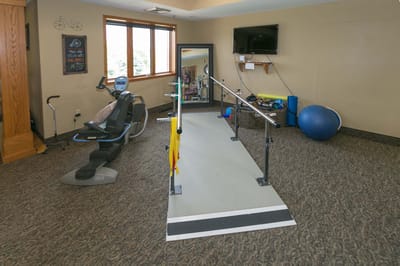 Rehabilitation exercise space with equipment and walking rails
