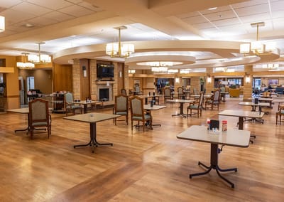 Dining area with tables and chairs in a spacious room