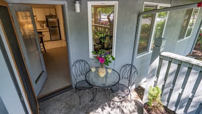 Outdoor seating area with flowers and drinks
