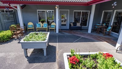 Outdoor seating area with flowers and planters