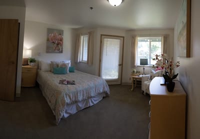Cozy, well-furnished resident room with floral decor