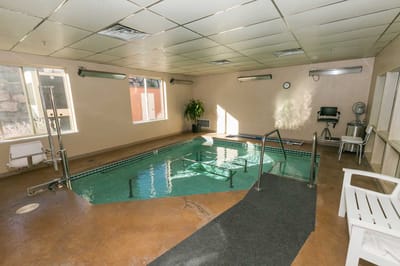 Indoor swimming pool area with aquatics amenities