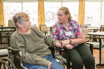 Caregiver interacting with a resident in a common area