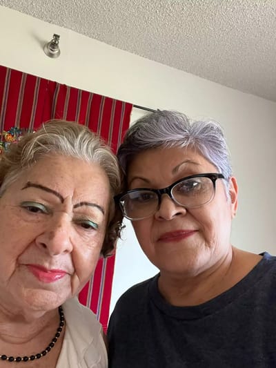 Two women smiling in a shared space