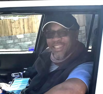 Smiling man sitting in a vehicle