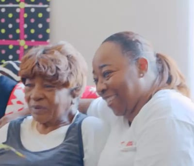 Two smiling women enjoying a moment together.