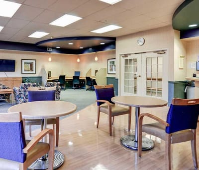 Bright common area with seating and workstations