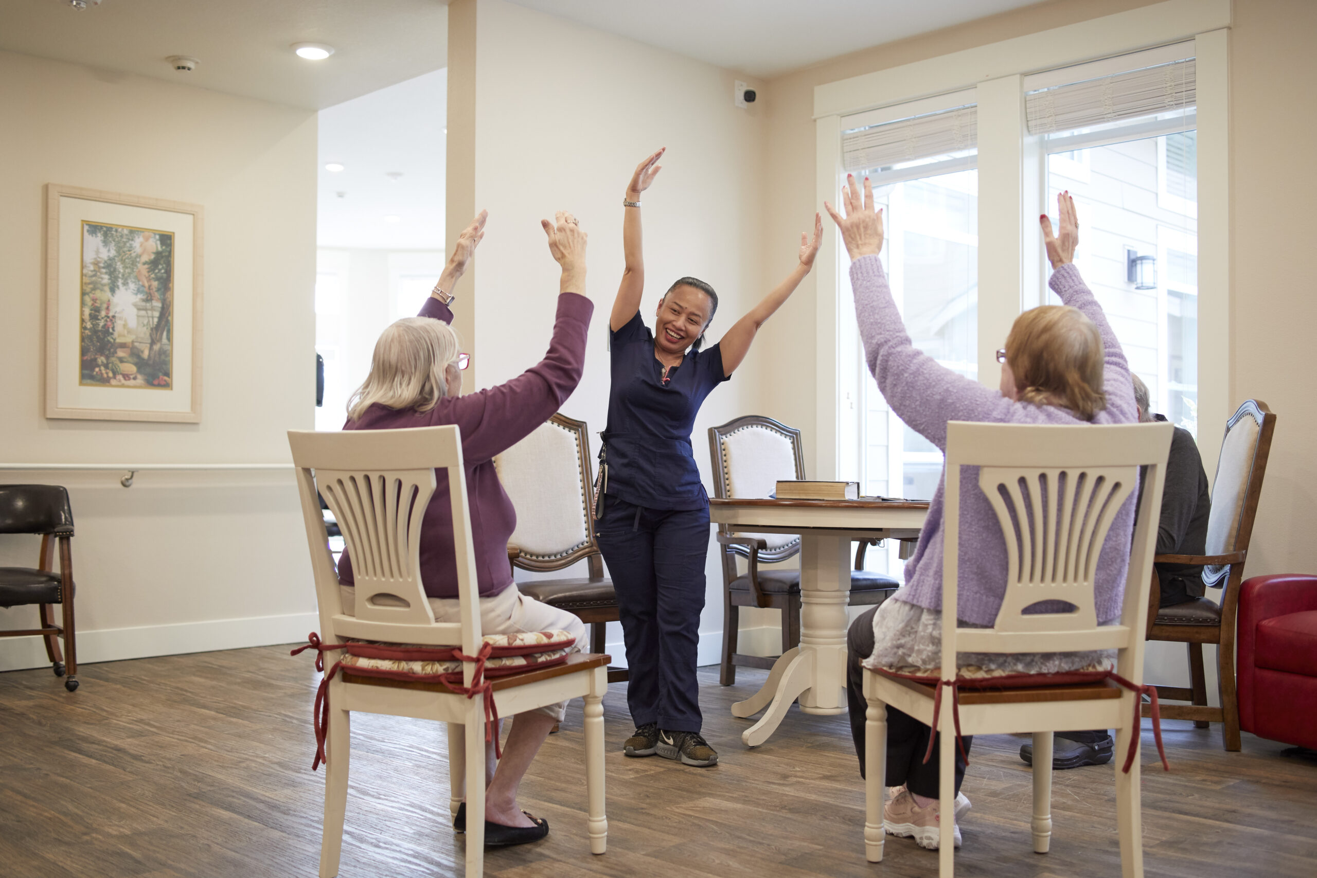 Staff leading an activity with engaged residents