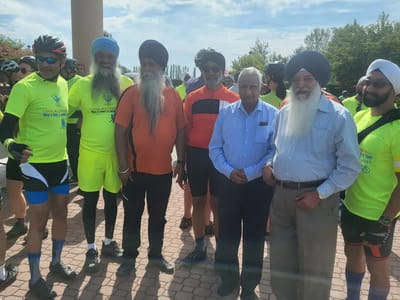 Group of men in cycling attire posing outdoors