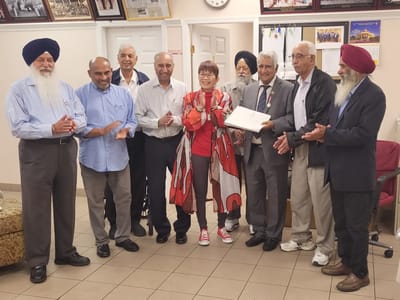 Residents and staff celebrating with a certificate