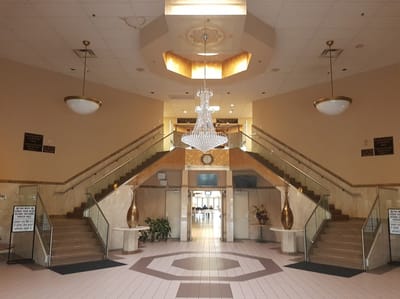 Interior view of the entrance lobby with staircase and chandelier