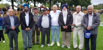 Group of men posing outdoors at an event