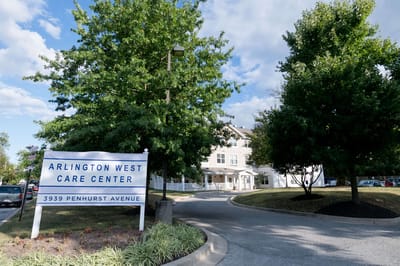 Exterior view of Arlington West Care Center with trees