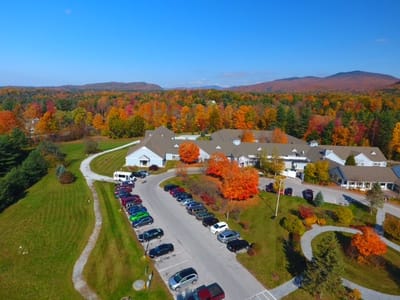 Aerial view of the facility surrounded by colorful autumn trees