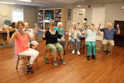 Residents participating in a group exercise class indoors