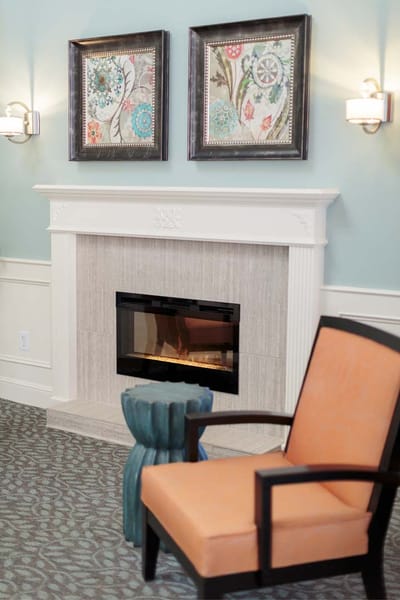 Interior common area with a fireplace and seating