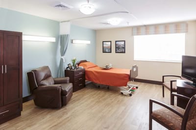 Private resident room with a bed and seating area