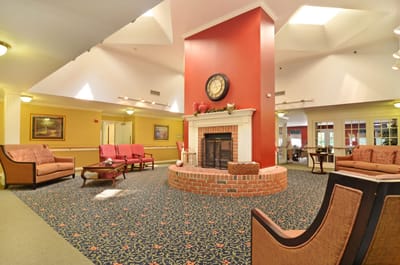 Bright common area with seating and a fireplace