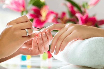 Nail care service with hands and flowers in background
