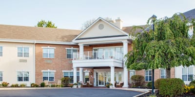 Exterior view of a senior living facility with landscaping