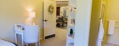 Brightly lit interior of a resident room with furnishings