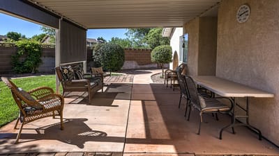 Outdoor patio area with seating and greenery.