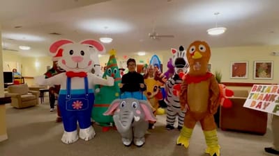 Residents and staff in colorful costumes during an activity