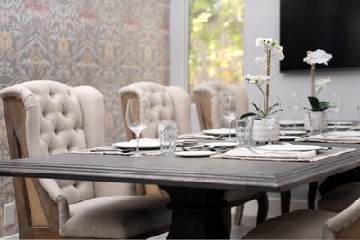 Elegant dining setup with stylish chairs and floral decor
