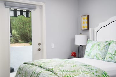 A cozy resident room with a bed and door to the outdoors