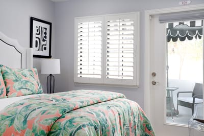 Cozy resident room with patterned bedding and outdoor view