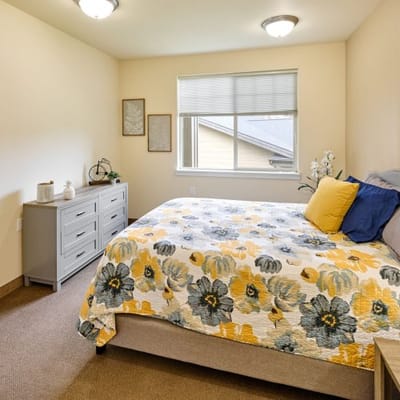 Cozy private room with floral bedding and natural light