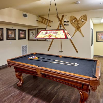 A billiards table in a common area recreation room