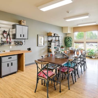 Well-lit craft room with a large table and supplies