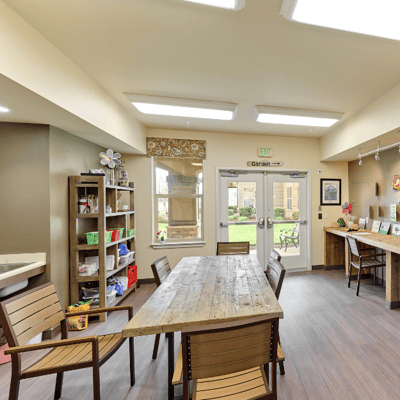 Bright common area with seating and garden view