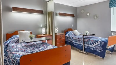 Bright interior of a shared resident room with beds and decor