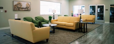 Bright common area with comfortable seating and decor