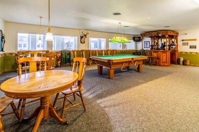 Common area with a pool table and dining setup