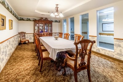 Elegant dining room with wooden furniture and floral wallpaper
