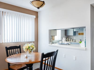 Bright interior of a dining area with chairs and a table
