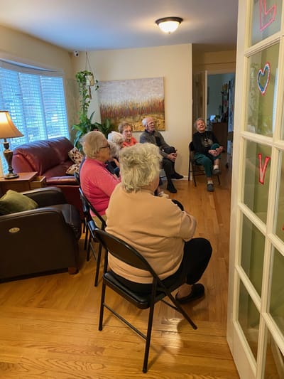 Residents engaged in conversation in a cozy living room