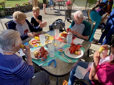 Residents enjoying a lobster feast outdoors